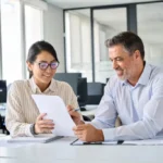 business professionals sitting at desk reviewing form